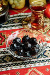 Jam of berries and ripe fruit. Restaurant dish with vegetable decor on a wooden background. Jam in a glass saucer.