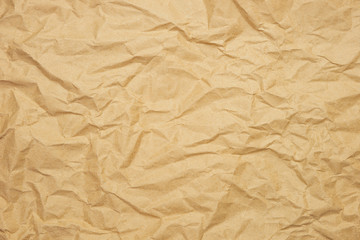Wrinkled brown paper background. Kraft paper texture for wrapping. Eco-friendly packaging concept. 