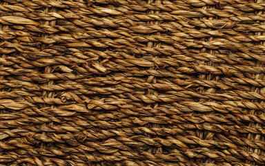 Real old brown basket texture with loose threads out. Weaving craft background. Twig basket surface. 