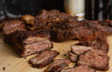 Baked pork cut into pieces on a wooden chopping board