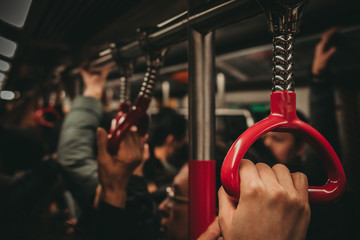 Metro in Hong Kong red handles people comuting to work