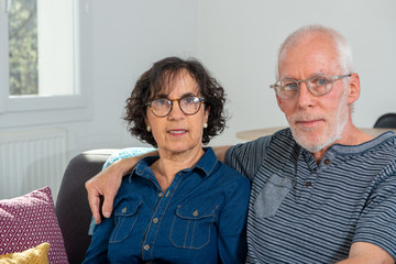 Senior couple relaxing on sofa at home