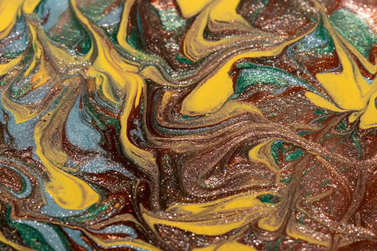 Abstract background of mixed shades of nail polish with a shiny