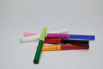 colored markers on a white background