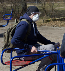 Masked people walk outdoors in the epidemic of coronavirus.