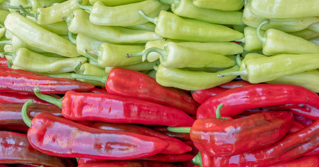red and green organic sweet horn peppers, bicolor natural background