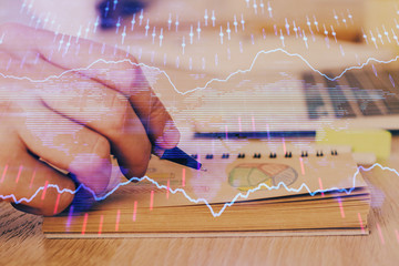 Multi exposure closeup hands with stock market forex graph.