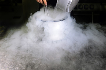 Chef is making ice cream with liquid nitrogen