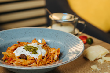 homemade pesto pasta with tomato and parmesan cheese