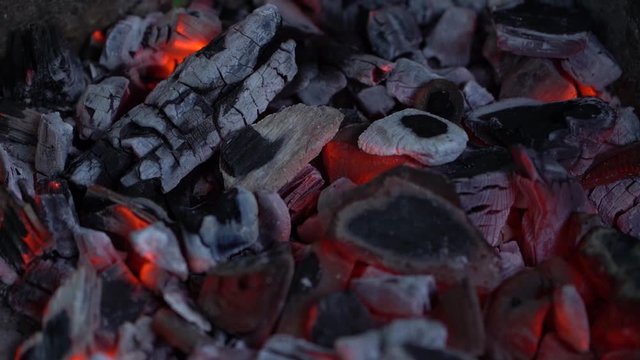 Closeup view video of texture of burned wood charcoal in grill ready for cooking grilled food.