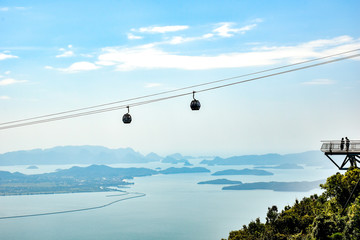 cable car in the mountains malaysian island with two people