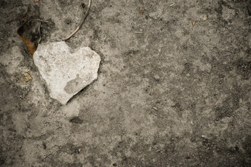 heart shaped stone on concrete floor