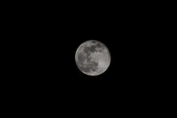 Super full moon on black night sky