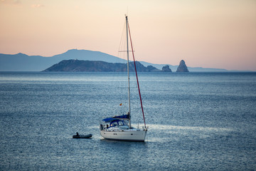 A sailboat at sunset in the mediterranean sea in front of Begur, Catalonia, Spain