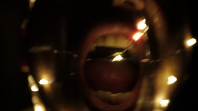 Trippy psycho wearing lit fairy lights in the dark 