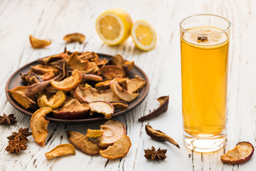 Dried fruits drink with lemon on a wooden background. Uzvar could be drunk cold or hot.