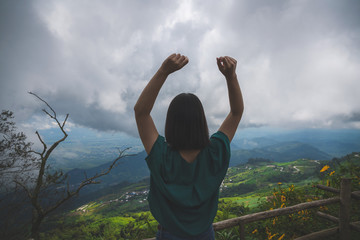 young cute Japanese Asian hipster girl travelling at beautiful sky 
mountains scenery park hiking views at Phu Thap Boek Phetchabun Thailand guiding 
idea for female backpacker woman women backpacking