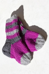 Time for hobbies. Knitting socks with stripes for children and friends.
