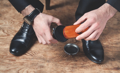 Man polishing shoes with a brush.