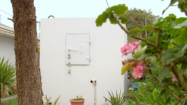Mobile bomb shelter inside a home garden in Israel. This is an extra Fortified Room that helps the house residents to be protected from rocket fire attacks. It called Migunit" or "Merkhav Mugan"."