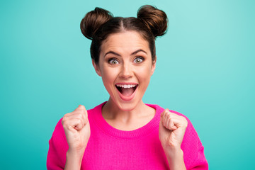 Close-up portrait of her she nice attractive lovely charming cheerful cheery lucky girl winner fan holding fists celebrating isolated over bright vivid shine vibrant blue turquoise color background