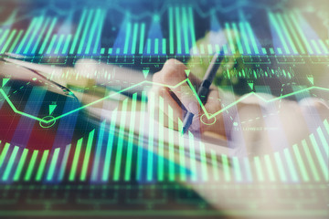 Double exposure of hands making notes background with technology and digital coding huds. Data learning concept.