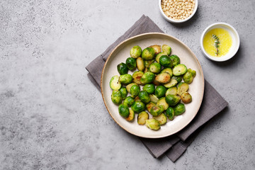 Brussels sprouts roasted with butter on gray slate background. Vegan Food Concept. Copy space, top view, flat lay