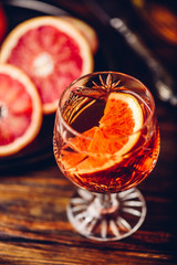 Blood orange whiskey sour cocktail with aged bourbon, blood orange juice, cherry syrup and cinnamon