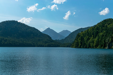 View of the Alpsee lake and the German Alps in the background in a beautiful picture on another plane. Photograph taken in Schwangau, Bavaria, Germany.