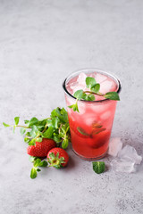 Strawberry mojito with lime and ice. Cold refreshing cocktail