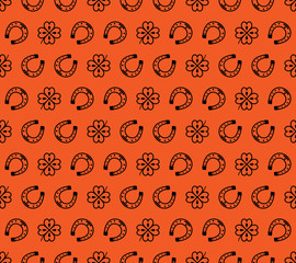 Seamless vector pattern with black clover leaves, shamrock and Horseshoe on a orange backdrop for St. Patrick's Day. Spring fest background for greetings card, decor, flyer, print, packaging etc.