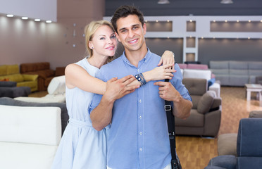 Portrait of a young couple who are happy in store