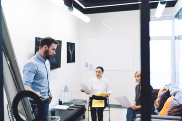Colleagues discussing business ideas in office room