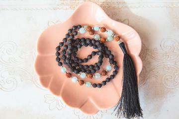 Indian rudraksha seed beads 108 mala necklace with Buddha pendant tassel on decorative backhround