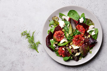 Beetroot salad with orange, cheese and mix of nuts, pumpkin seeds. Bright salad for cleen eating, detox