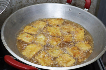 Cooking deep fried tempeh, Indonesian traditional meal, tempe goreng or gorengan