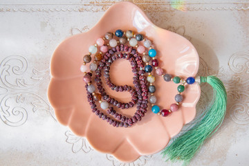 Indian rudraksha seed beads 108 mala necklace with Buddha pendant tassel on decorative backhround