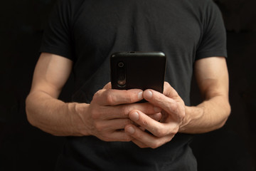 close view of thin male hands holding a phone