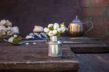 pear flowers in a vintage metal vase