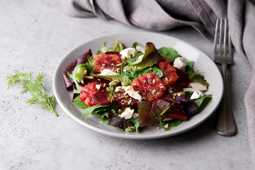 Beet root salad with orange, cheese and mix of nuts, pumpkin seeds. Bright salad for cleen eating, detox