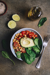 Spinach chickpea salad with avocado and tomatoes. Healthy balanced vegetarian food concept, buddha bowl, vegetable appetizer plate