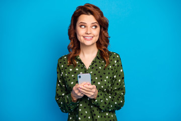 Photo of attractive funny lady hold telephone hands addicted user look interested side empty space...
