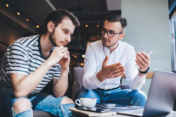 Entrepreneurs discussing data from laptop