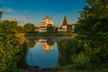 Fototapeta na wymiar Mirror surface of the lake of Joseph-Volotsky Monastery. Beautiful lake near the Joseph-Volotsky Monastery. The cloister is located in the village of Teryaevo.