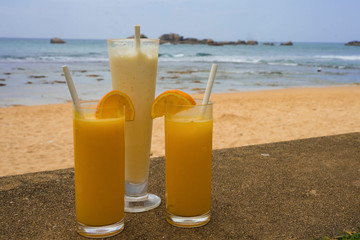 orange juice in transparent glasses and a milkshake