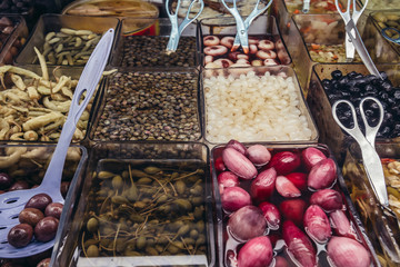 Variety of marinated food in a shop on covered food market - Mercato Delle Erbe in historic part of Bologna city, Italy © Fotokon