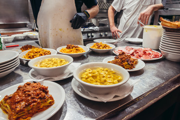 Italian food served in restaurant in historic part of Bologna city, Italy © Fotokon