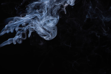 white flowing smoke cloud on black background with copy space