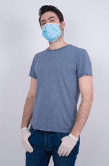 Young handsome man wearing white T-shirt over isolated background happy face smiling with hands in pockets looking at the camera. Positive person.