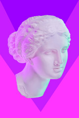 Statue of Venus de Milo. Creative concept colorful neon image with ancient greek sculpture Venus or Aphrodite head. Webpunk, vaporwave and surreal art style. Pink and blue duotone effects.